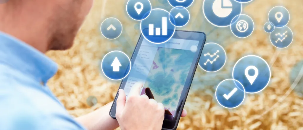 PROMO HIRES Agriculture - Stats Statistics Tablet Symbols Farm Ranch - iStock - monkeybusinessimages Person standing in a wheat field using a tablet device with agriculture icons imposed